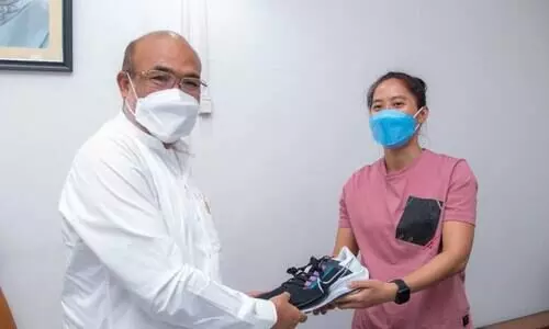 SPORTS Indias ace footballer Bala Devi gifts running shoes to Manipur CM