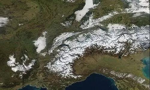 Climate change turning snow covered white Alps green