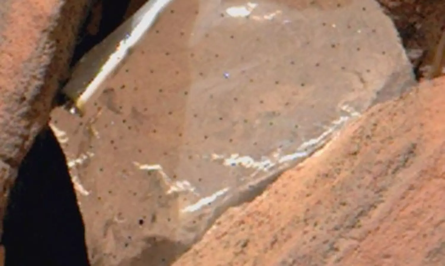 NASA Mars rover spots shiny foil piece between rocks