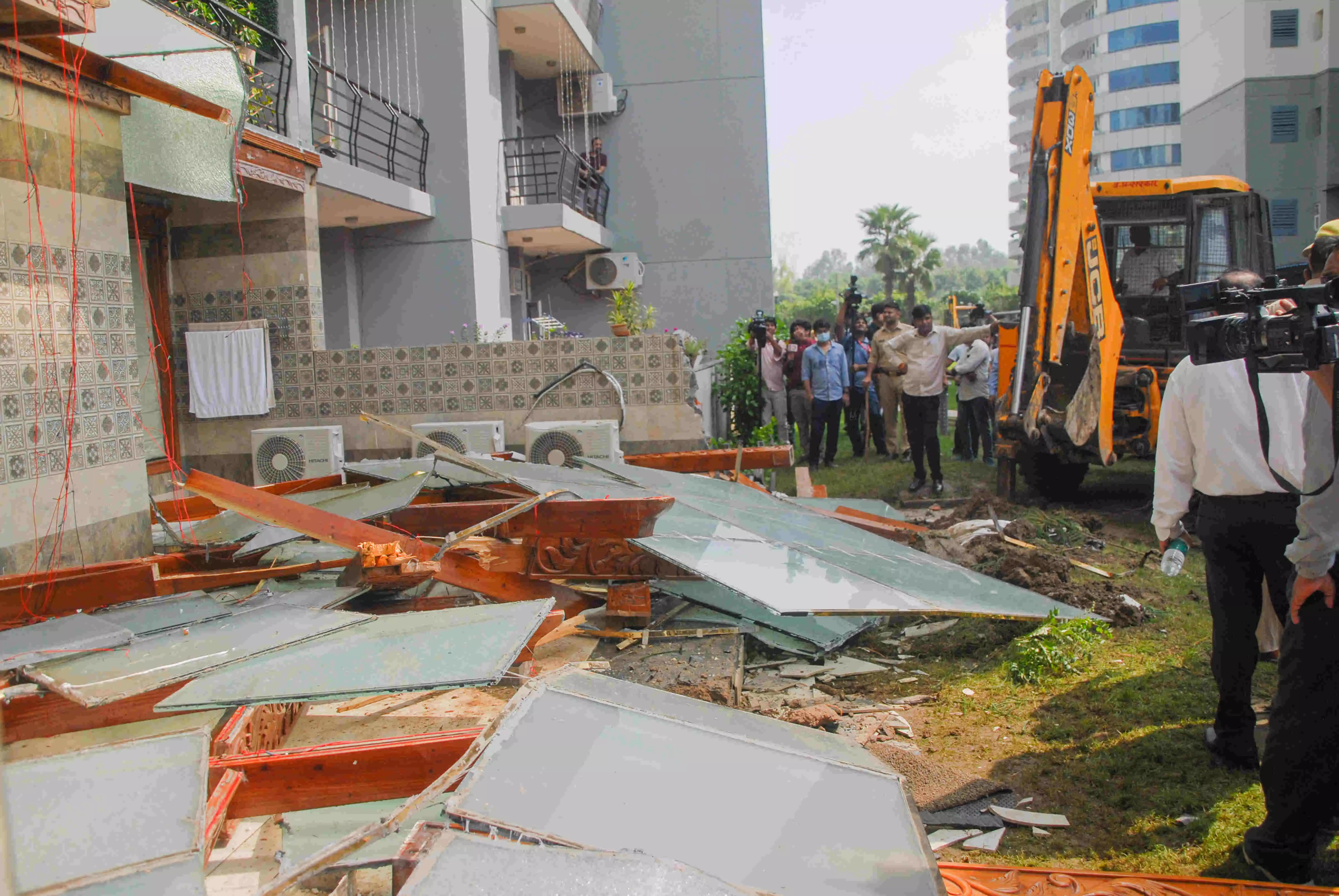 Bulldozer removes illegal structures outside politician Shrikant Tyagis Noida flat
