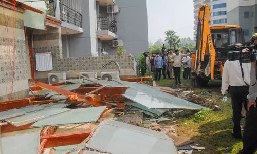 Bulldozer removes illegal structures outside politician Shrikant Tyagis Noida flat