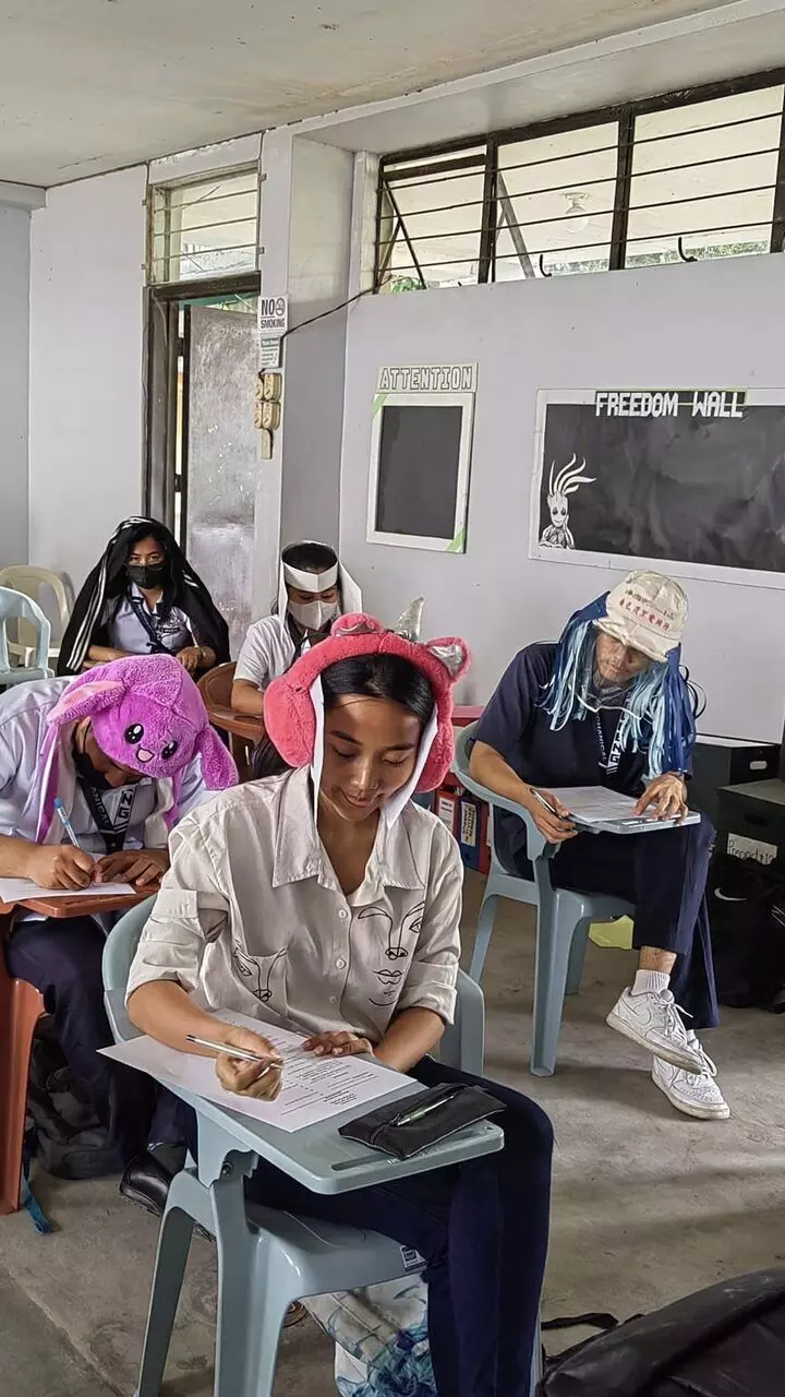 Students from Phillipines don anti-cheat head gears