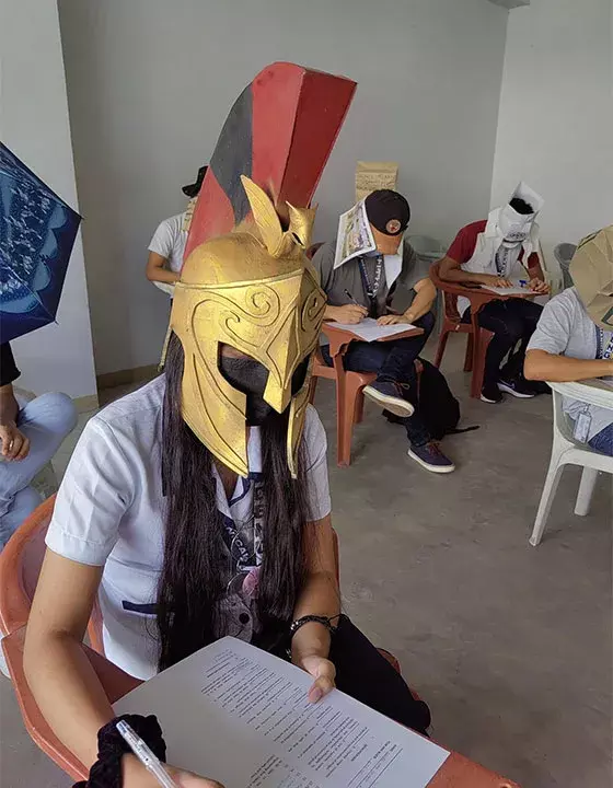Students from Phillipines don anti-cheat head gears