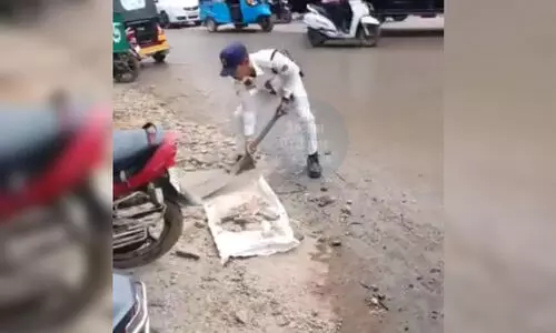 Silchar traffic official picks up pieces of leftover bricks, stones; act wins peoples heart