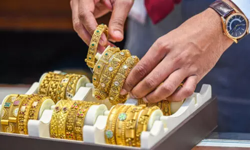 Gold prices climb from 1-week low amid weaker dollar, festive demand