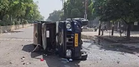 Violence erupts in Noida workers protest; vehicles torched as agitators clash with police Violence erupts in Noida workers protest; vehicles torched as agitators clash with police
