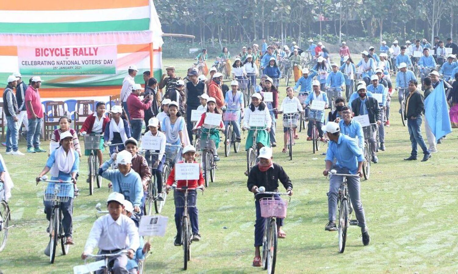 A bicycle rally being brought out at Mushalpur, and (right) children taking part in a rangoli competition at Dergaon on the occasion of Voters Day on Monday. – UB/Correspondent